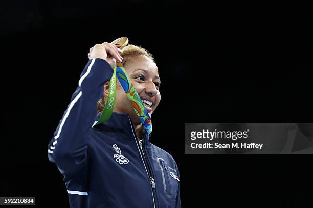 Gold medalist Estelle Mossely of France celebrates on the podium after winning the Women's Light Final Bout Day 14 of the Rio 2016 Olympic Games at...