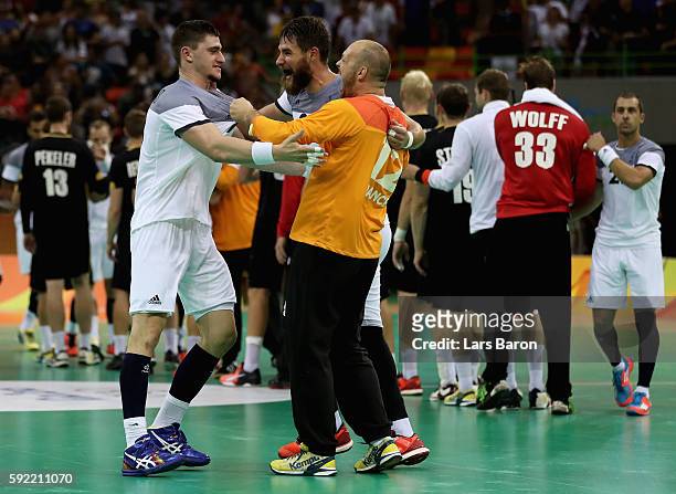 Team France celebrates their victory in the Men's Handball Semifinal match between France and Germany on Day 14 of the Rio 2016 Olympic Games at...