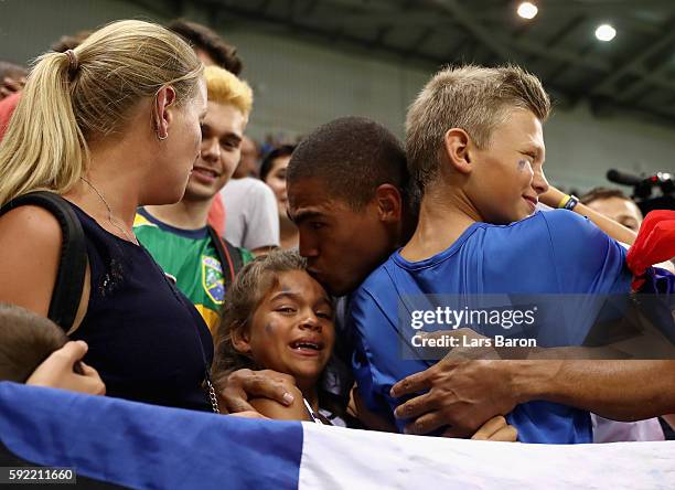 Daniel Narcisse of France celebrates their victory with his children after the Men's Handball Semifinal match between France and Germany on Day 14 of...