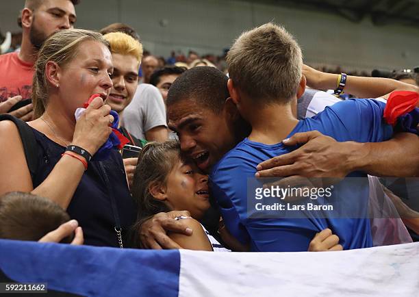 Daniel Narcisse of France celebrates their victory with his children after the Men's Handball Semifinal match between France and Germany on Day 14 of...