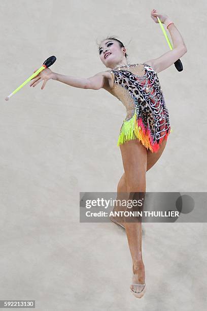 An overview shows Japan's Kaho Minagawa competing in the individual all-around qualifying event of the Rhythmic Gymnastics at the Olympic Arena...