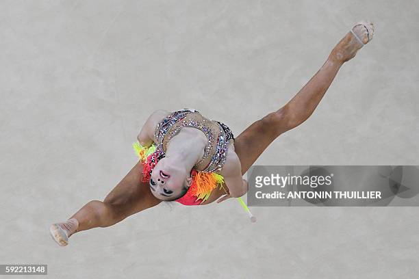 An overview shows Japan's Kaho Minagawa competing in the individual all-around qualifying event of the Rhythmic Gymnastics at the Olympic Arena...