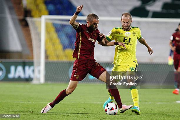 Marko Devic of FC Rubin Kazan challenged by Ivan Mayewski of FC Anji Makhachkala during the Russian Premier League match between FC Rubin Kazan and...