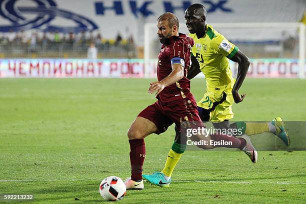 Gokdeniz Karadeniz of FC Rubin Kazan challenged by Cedric Yambere of FC Anji Makhachkala during the Russian Premier League match between FC Rubin...