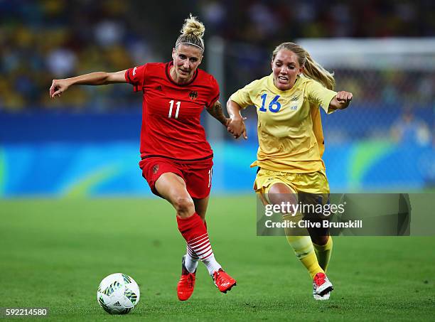 Anja Mittag of Germany holds off the challenge of Elin Rubensson of Sweden during the Women's Olympic Gold Medal match between Sweden and Germany at...