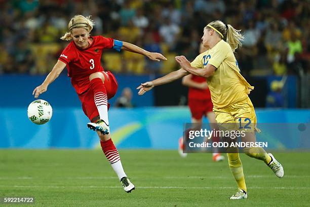 Germany's defender and captain Saskia Bartusiak and Sweden's striker Olivia Schough vie for the ball during the Rio 2016 Olympic Games women's...