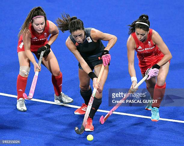 Netherlands' Naomi van As vies with Britain's Laura Unsworth and Britain's Sam Quek during the women's Gold medal hockey Netherlands vs Britain match...