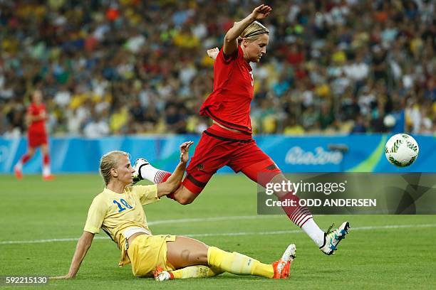 Sweden's striker Sofia Jakobsson and Germany's defender and captain Saskia Bartusiak vie for the ball during the Rio 2016 Olympic Games women's...