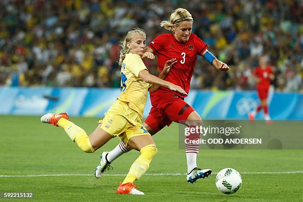 Sweden's striker Sofia Jakobsson and Germany's defender and captain Saskia Bartusiak vie for the ball during the Rio 2016 Olympic Games women's...