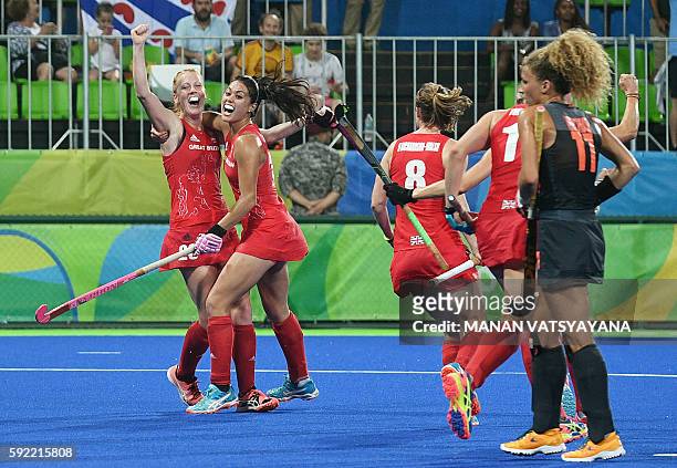 Britain's Nicola White celebrates with teammate Britain's Sam Quek after scoring a goal during the women's Gold medal hockey Netherlands vs Britain...