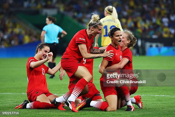 Dzsenifer Marozsan of Germany is congratulated by team mates after scoring during the Women's Olympic Gold Medal match between Sweden and Germany at...