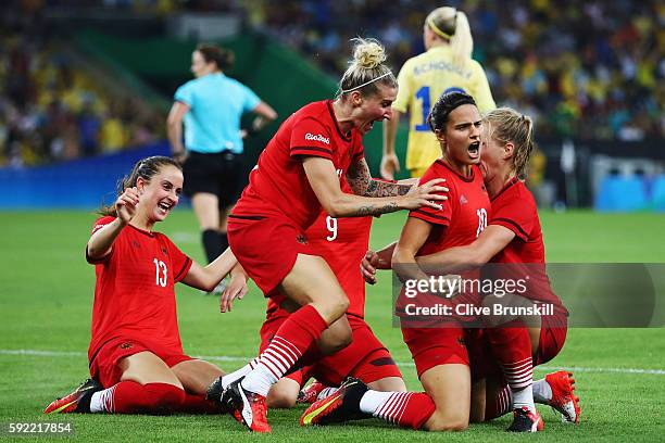 Dzsenifer Marozsan of Germany is congratulated by team mates after scoring during the Women's Olympic Gold Medal match between Sweden and Germany at...