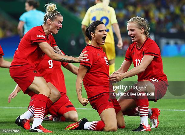 Dzsenifer Marozsan of Germany is congratulated by team mates after scoring during the Women's Olympic Gold Medal match between Sweden and Germany at...