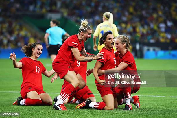 Dzsenifer Marozsan of Germany is congratulated by team mates after scoring during the Women's Olympic Gold Medal match between Sweden and Germany at...