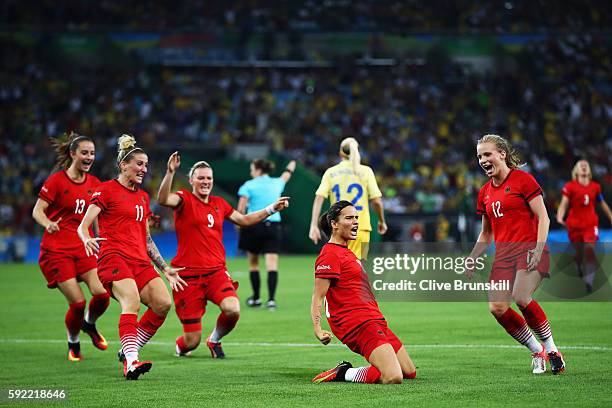 Dzsenifer Marozsan of Germany is congratulated by team mates after scoring during the Women's Olympic Gold Medal match between Sweden and Germany at...