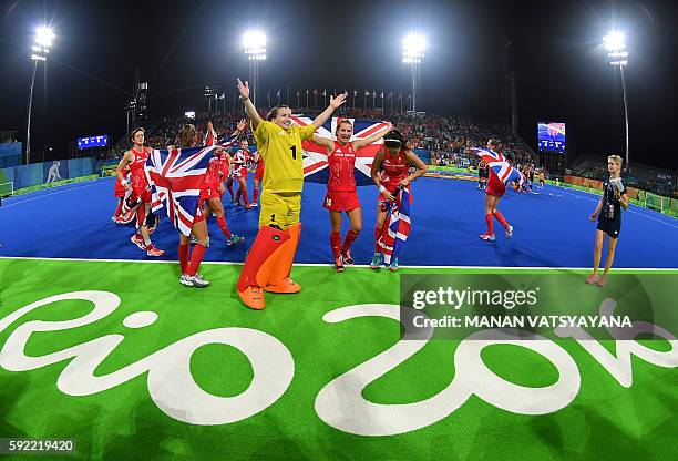 Britain's players celebrate their victory at the end of the women's Gold medal hockey Netherlands vs Britain match of the Rio 2016 Olympics Games at...