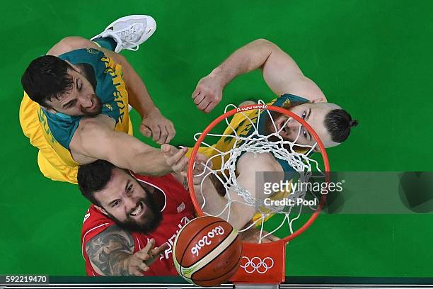 Miroslav Raduljica of Serbia goes to the basket against Andrew Bogut and Aron Baynes of Australia during the Men's Semifinal match on Day 14 of the...