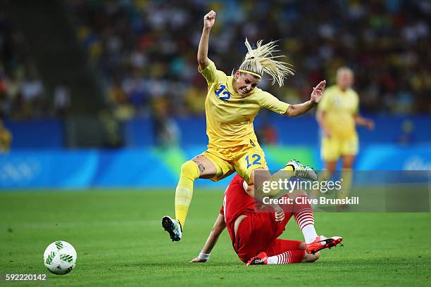 Olivia Schough of Sweden clears the challenge of Alexandra Popp of Germany during the Women's Olympic Gold Medal match between Sweden and Germany at...