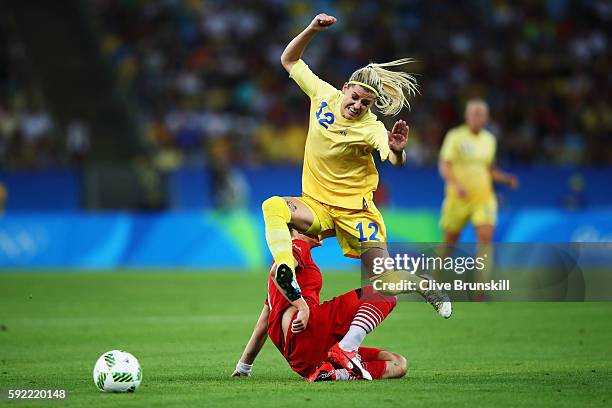 Olivia Schough of Sweden clears the challenge of Alexandra Popp of Germany during the Women's Olympic Gold Medal match between Sweden and Germany at...