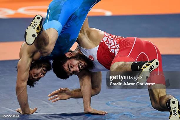 Soner Demirta of Turkey and Galymzhan Usserbayev of Kazakhstan scramble during their men's 74kg freestyle wrestling bronze medal match on Friday,...