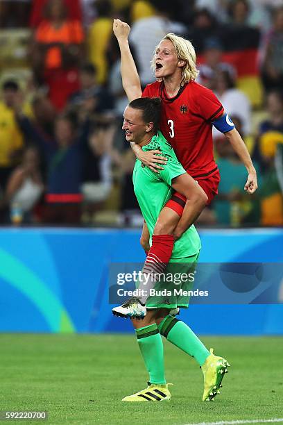 Almuth Schult of Germany and Saskia Bartusiak of Germany celebrate victory in the Women's Olympic Gold Medal match between Sweden and Germany at...