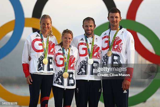 Saskia Clark of Great Britain, Hannah Mills of Great Britain, Nick Dempsey of Great Britain and Giles Scott of Great Britain pose with their Olympic...