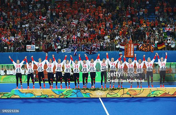 Great Britain celebrates on the podium after winning a penalty shoot out during the Women's Hockey final between Great Britain and the Netherlands on...