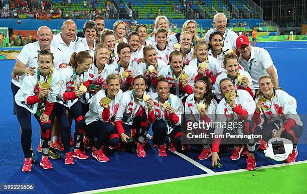 Team Great Britain pose with their gold medals after defeating Netherlands in the Women's Gold Medal Match on Day 14 of the Rio 2016 Olympic Games at...