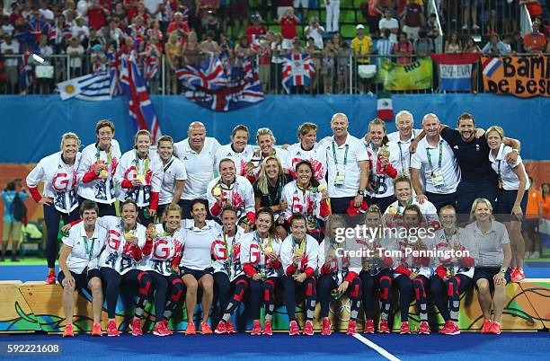 Team Great Britain pose with their gold medals after defeating Netherlands in the Women's Gold Medal Match on Day 14 of the Rio 2016 Olympic Games at...