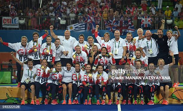 Britain's gold medallists celebrate on the podium during the women's field hockey medals ceremony of the Rio 2016 Olympics Games at the Olympic...