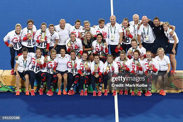 Team Great Britain pose with their gold medals after defeating Netherlands in the Women's Gold Medal Match on Day 14 of the Rio 2016 Olympic Games at...