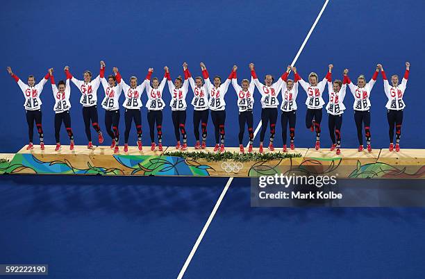 Team Great Britain pose on the podium during the medal ceremony after defeating Netherlands in the Women's Gold Medal Match on Day 14 of the Rio 2016...