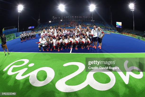 Team Great Britain pose with their gold medals after defeating Netherlands in the Women's Gold Medal Match on Day 14 of the Rio 2016 Olympic Games at...