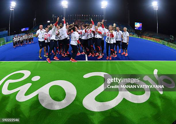 Britain's players pose with their gold medals during the women's field hockey medals ceremony of the Rio 2016 Olympics Games at the Olympic Hockey...