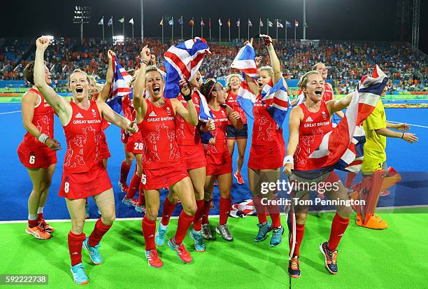 Team Great Britain celebrate after defeating Netherlands in the Women's Gold Medal Match on Day 14 of the Rio 2016 Olympic Games at the Olympic...