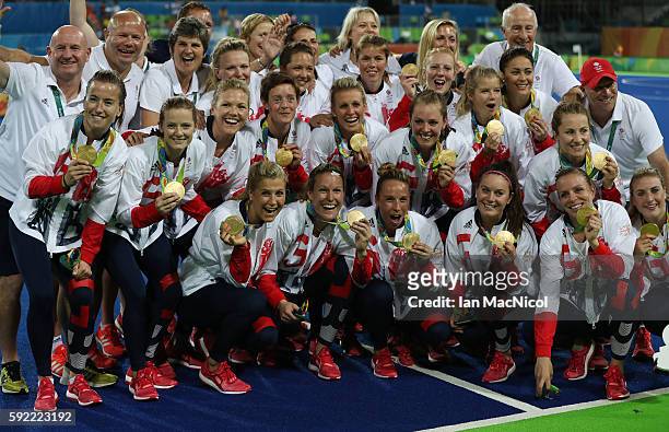 Great Britain celebrates with their medals after winning a penalty shoot out during the Women's Hockey final between Great Britain and the...