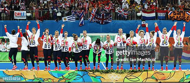 Great Britain celebrate on the podium after winning a penalty shoot out during the Women's Hockey final between Great Britain and the Netherlands on...