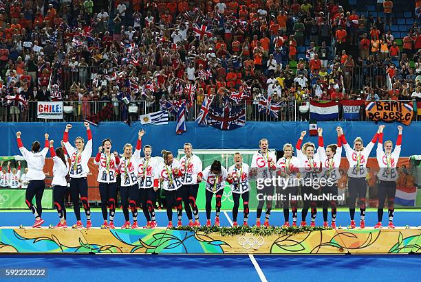 Great Britain celebrate on the podium after winning a penalty shoot out during the Women's Hockey final between Great Britain and the Netherlands on...