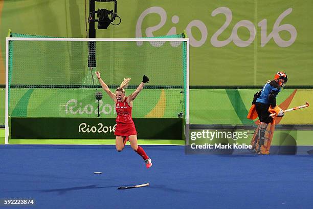 Hollie Webb of Great Britain celebrates scoring the winning penalty goal past Joyce Sombroek of Netherlands in the Women's Bronze Medal Match on Day...