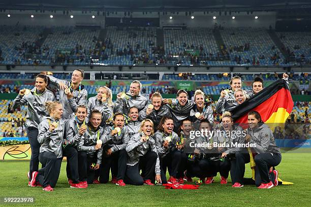 Germany celebrate with their gold medals following victory during the Women's Olympic Gold Medal match between Sweden and Germany at Maracana Stadium...