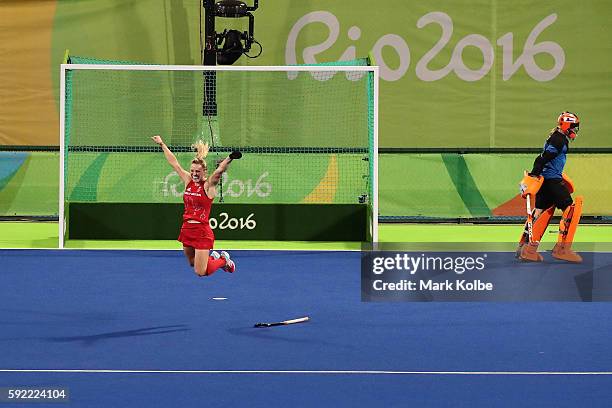 Hollie Webb of Great Britain celebrates scoring the winning penalty goal past Joyce Sombroek of Netherlands in the Women's Bronze Medal Match on Day...