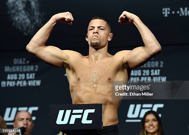 Mixed martial artist Nate Diaz poses on the scale during his weigh-in for UFC 202 at MGM Grand Conference Center on August 19, 2016 in Las Vegas,...
