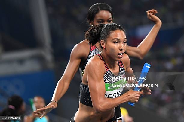 Canada's Alicia Brown runs with the baton in the Women's 4x400m Relay Round 1 during the athletics event at the Rio 2016 Olympic Games at the Olympic...