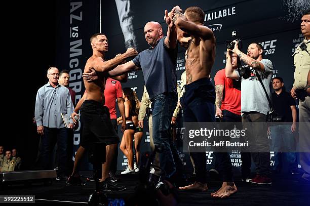 Nate Diaz and Conor McGregor of Ireland face off during the UFC 202 weigh-in at the MGM Grand Marquee Ballroom on August 19, 2016 in Las Vegas,...