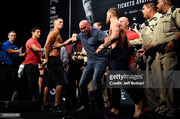 Nate Diaz and Conor McGregor of Ireland face off during the UFC 202 weigh-in at the MGM Grand Marquee Ballroom on August 19, 2016 in Las Vegas,...