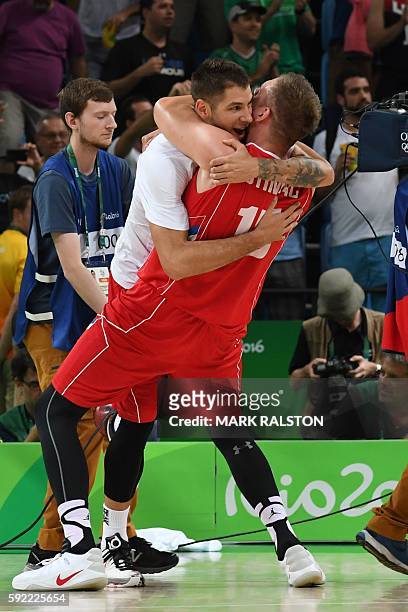 Serbia's guard Stefan Jovic embraces Serbia's centre Vladimir Stimac after Serbia defeated Australia during a Men's semifinal basketball match...