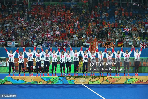Team Great Britain pose on the podium during the medal ceremony after defeating Netherlands in the Women's Gold Medal Match on Day 14 of the Rio 2016...