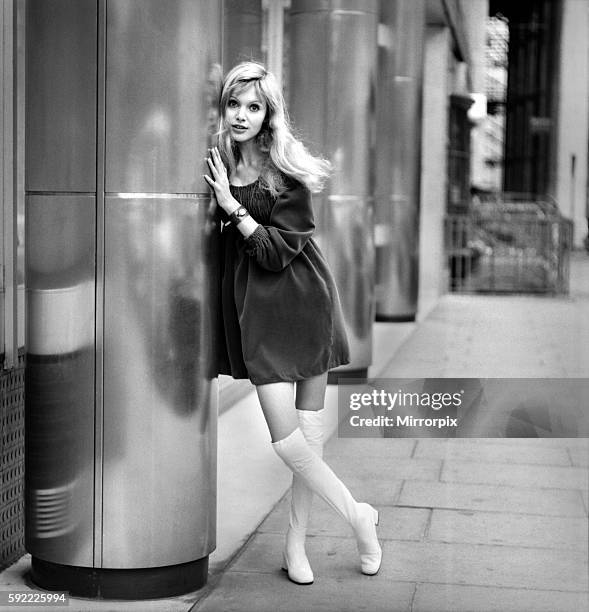 Actress and model Maddy Smith aged 20 photographed in London wearing a black dress and fwhite knee high boots November 1969 Z10608-006