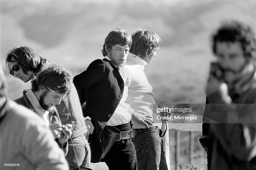 Rolling Stones singer Mick Jagger who plays the lead role in the film Ned Kelly, relaxes on the bridge during a break in