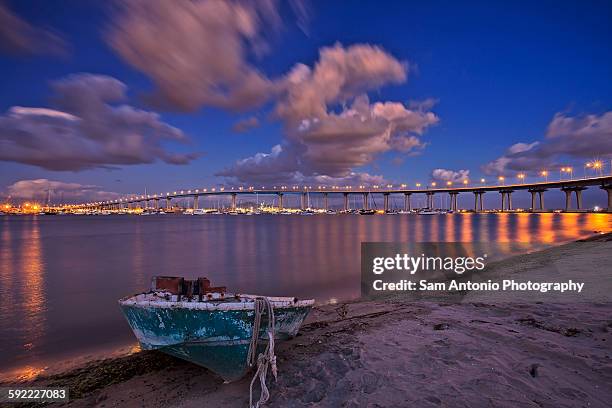 view of the coronado bay bridge and shoreline boat - san diego bridge stock pictures, royalty-free photos & images